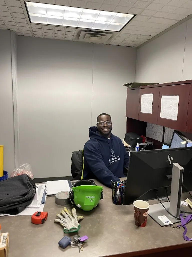 picture of ola akinsunmade in office wearing The Engineer's Perspective hoodie