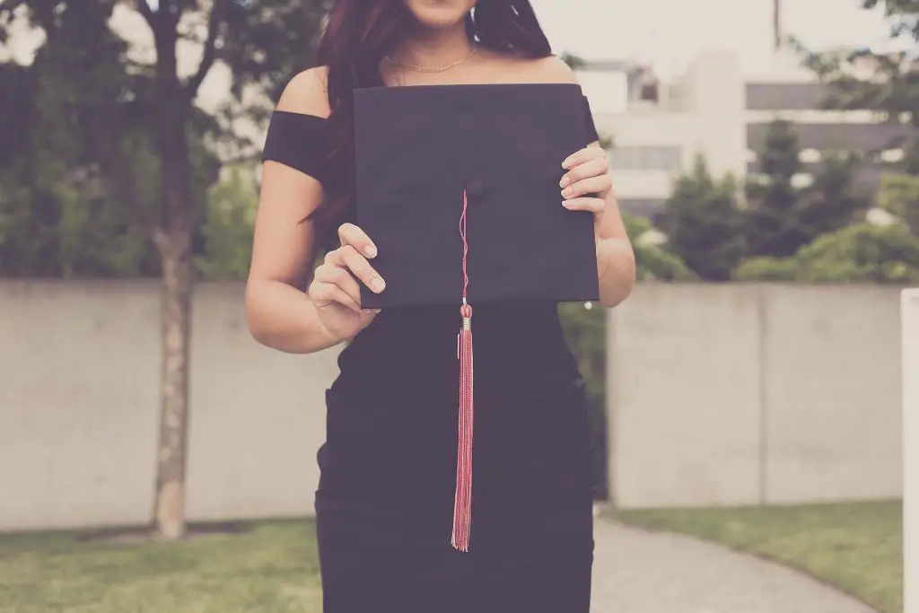 Picture of woman holding graduation hat